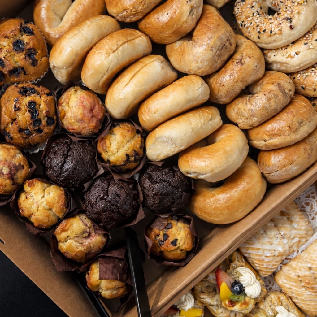 Power bagel tray with assorted bagels, muffins, and fresh fruit pastries