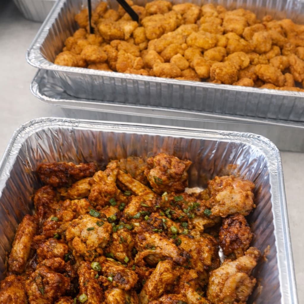 Trays of buffalo and breaded wings with herbs and seasoning